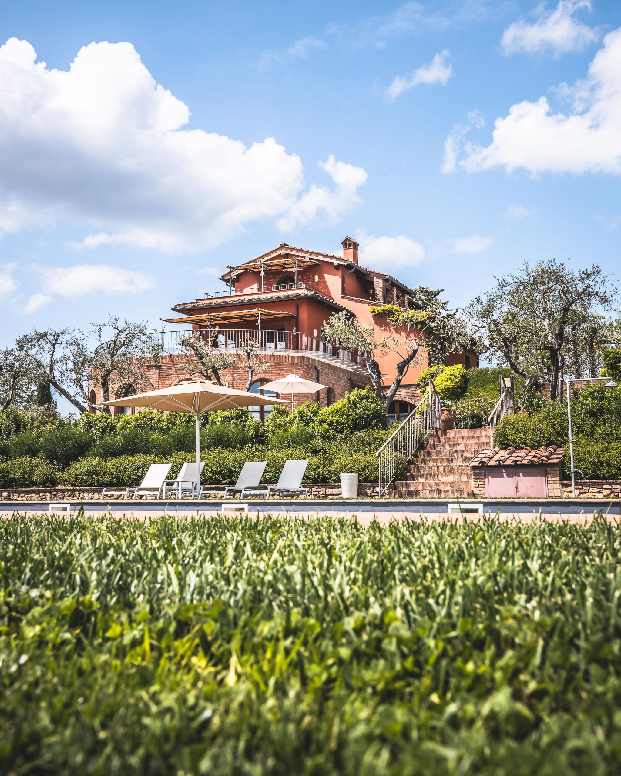 A beautiful villa and garden under blue skies, perfect for a serene vacation.