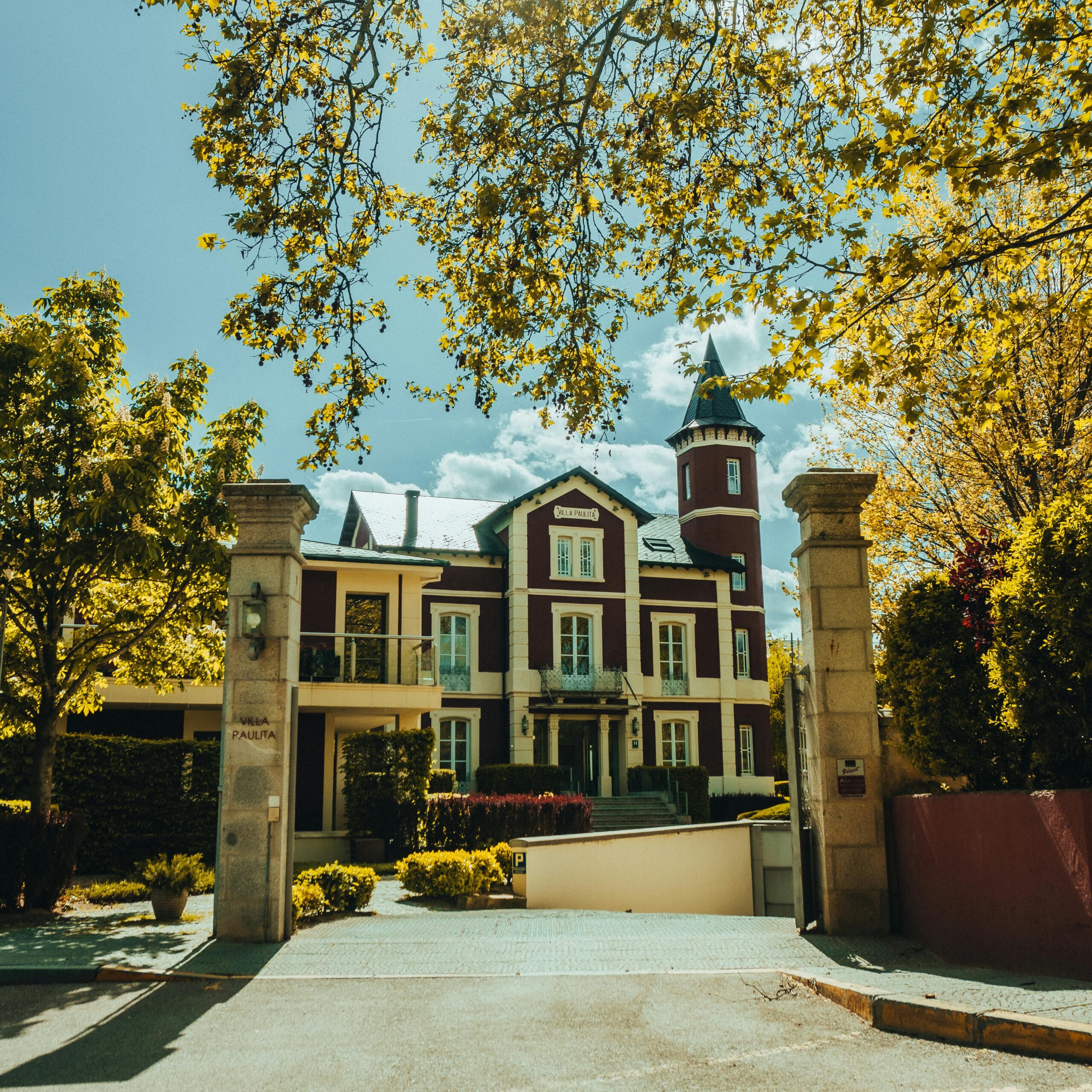 Picturesque view of Villa Paulita surrounded by lush green trees in Girona, Spain.